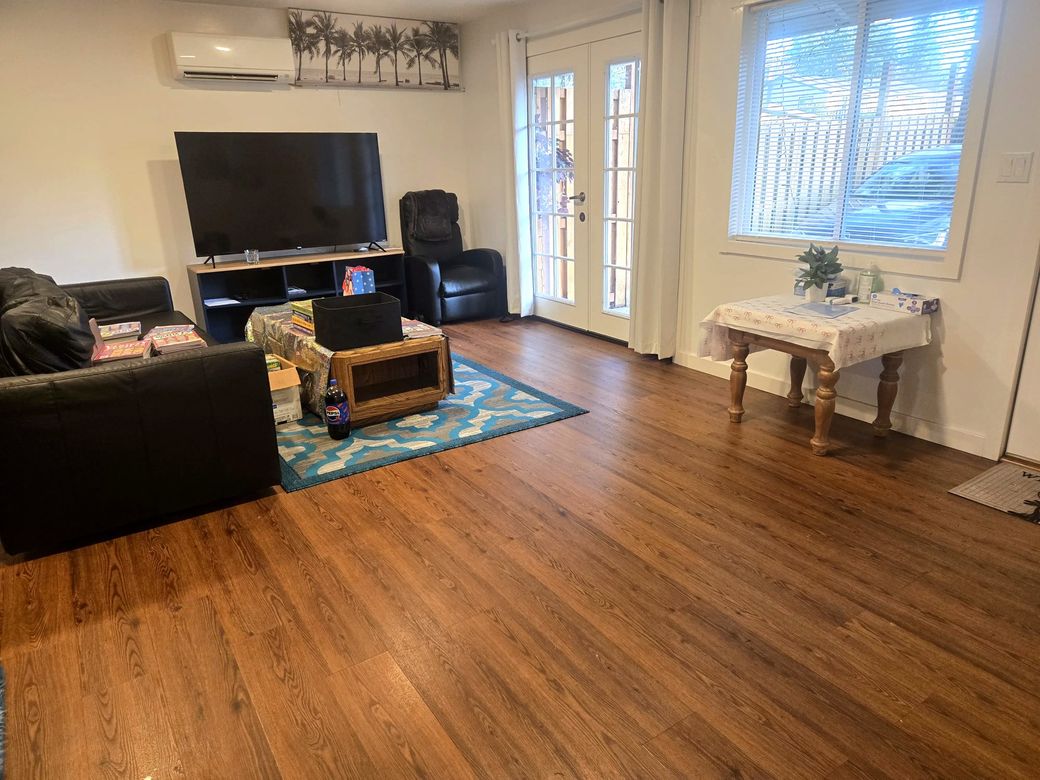 Bright living room with hardwood floors and patio doors