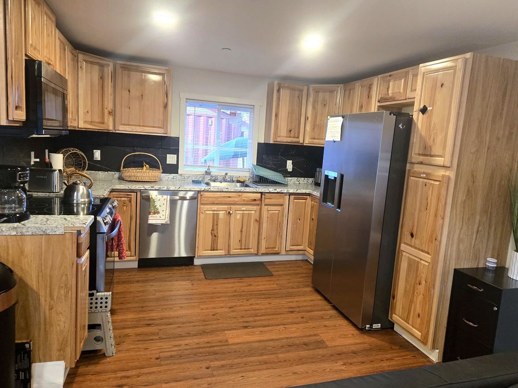 Full kitchen with hickory cabinets and stainless-steel appliances